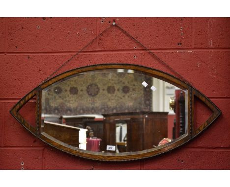 An unusual 1930's oak wall mirror, ocular shaped frame.