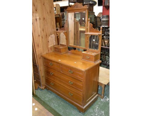 An Edwardian satinwood dressing chest, rectangular mirror flanked by two smaller over short drawers to superstructure, two sh