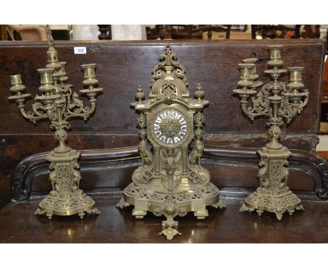 A Japy Freres brass clock garniture in the Empire taste, the clock with domed pediment and urnular finials, sphinx caryatids,
