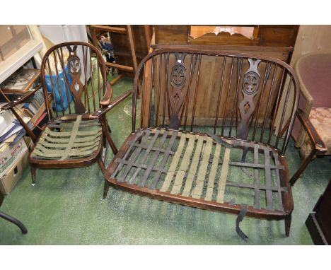 Two Ercol spindle back carvers , two conforming dining chairs ; an Ercol two piece suite comprising  two seat sofa and an arm