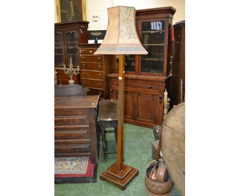 A 1930/40's mahogany standard lamp, spreading square column carved with flowerheads, stepped square base.
