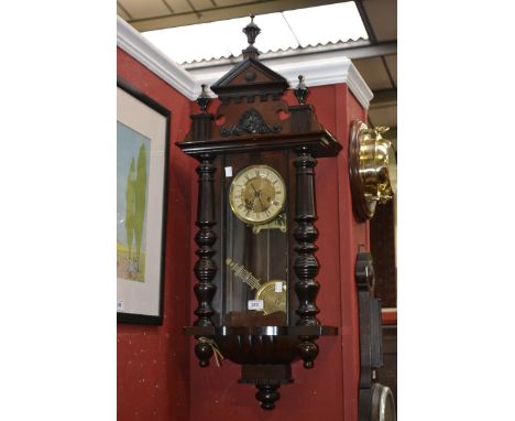 A mahogany and oak Vienna wall clock, architectural pediment with urnular finials, enamelled chapter ring, Roman numerals, ar