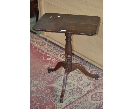 A George III oak tilt-top tripod occasional table, rounded rectangular top, turned baluster column, cabriole supports.