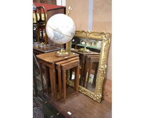 A 20th century ornate giltwood mirror; a walnut nest of tables c.1940; 20th century globe (3)