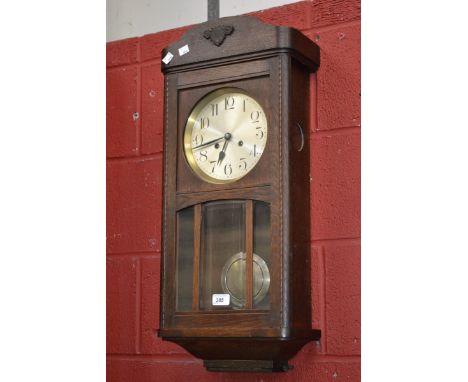 An oak wall clock, silvered dial, Arabic numerals, c.1940