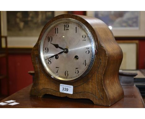 An oak cased chiming mantel clock, silvered dial, Arabic numerals, c 1920 
