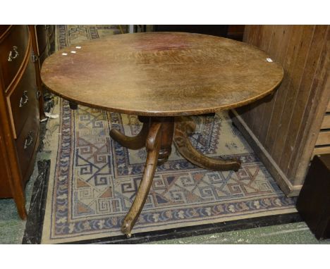 A Victorian oak tripod table, circa 1860.