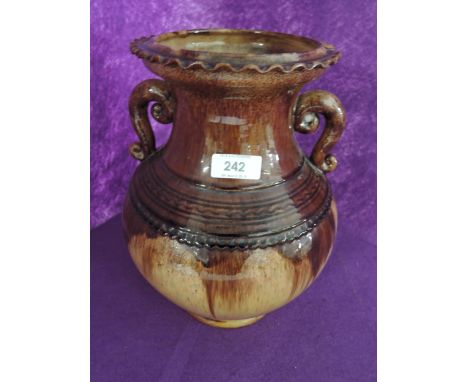 A slip glazed ceramic urn