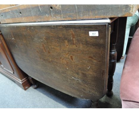 A mid to late 20th Century oak gate leg dining table