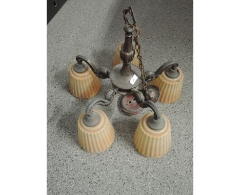 A vintage ceiling light fitment with original glass shades