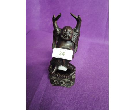 A vintage happy Buddha figure from ethnic carved woood