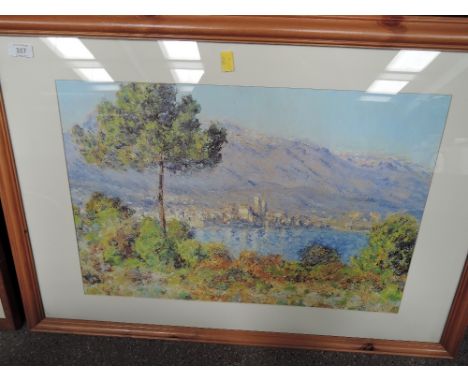 A large impressionist print in modern pine frame