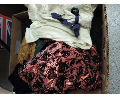 A box of various vintage clothing