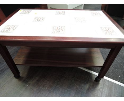 A vintage tile top coffee table, on castors
