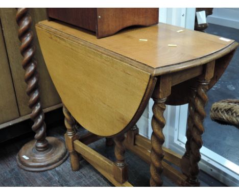 An early 20th Century golden oak twist gate leg table