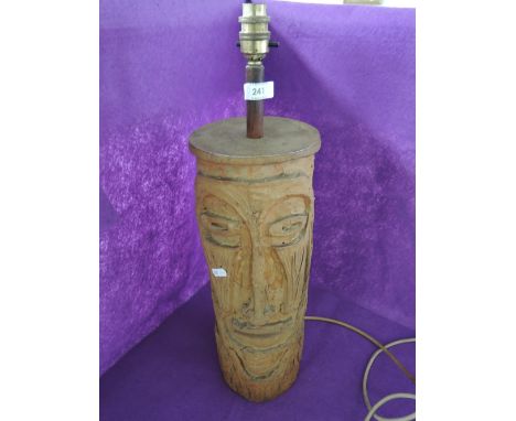 A ceramic lamp in the form of a native deity 