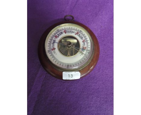 A vintage barometer in bulls eye design and enamel face