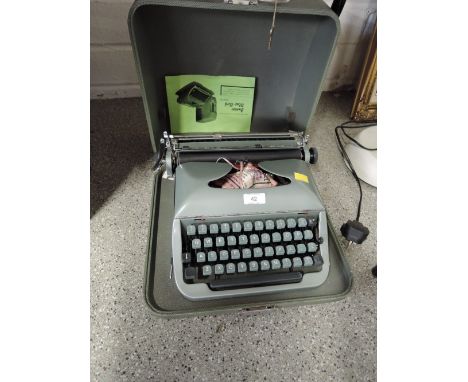 A vintage Junior Baby Bird typewriter with carry case