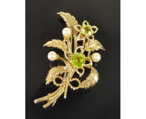 A 9ct yellow gold, peridot and pearl floral spray brooch, featuring a 5.2mm and 6.1mm round peridot each in flower settings w