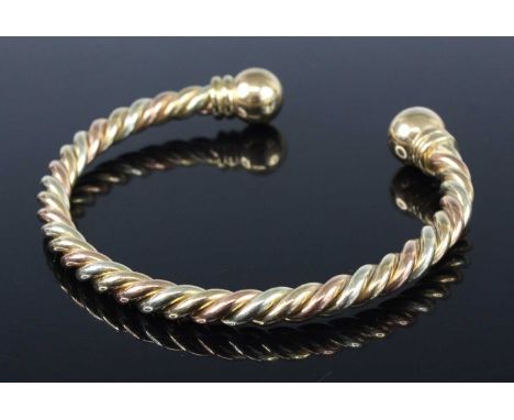 A contemporary three colour 9ct gold torque bangle, of rope twist design, sponsor JN, 32.8g, dia. 7cmIn excellent condition w