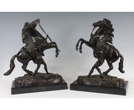After Guillaumei Costou (1677-1746) - a pair of bronze Marly horses with horsemen, each in prancing pose and raised upon poli