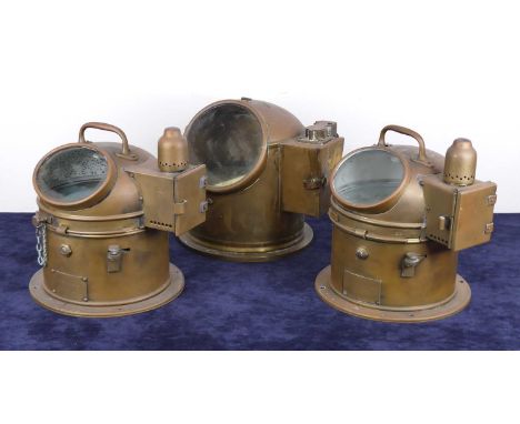 An early 20th century brass ships binacle compass, with glass viewing window, h.26cm, together with two other similar example
