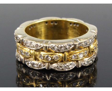 A yellow and white metal diamond three-row full hoop eternity ring, each row with 24 round brilliant cut diamonds set in leaf