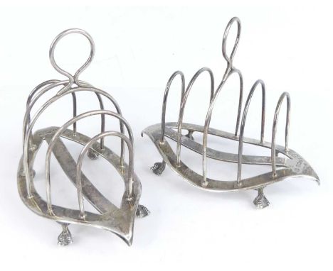A pair of late Victorian silver toast racks, each of elongated oval form with rounded arched dividers, with applied loop hand