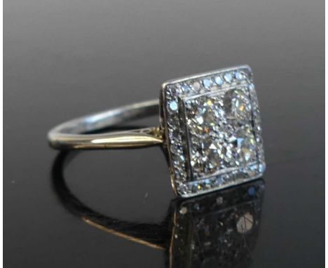 A white metal diamond square cluster ring featuring a centre quatrefoil of old European cut diamonds within a border of 28 si