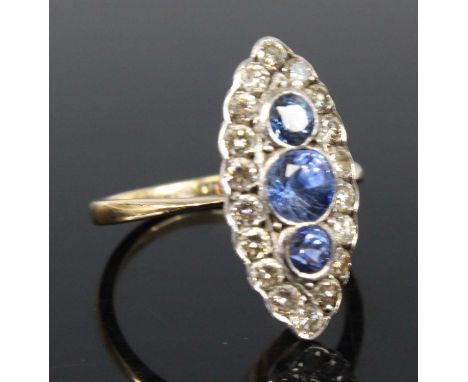 A yellow and white metal, sapphire and diamond navette style cluster ring, featuring three graduated round sapphires within a