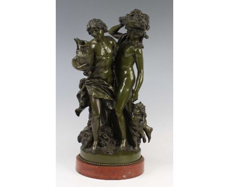 After Clodion (1738-1840) - a bronze Bacchanalian group, green patina, modelled as a youth and a maiden accompanied by a putt