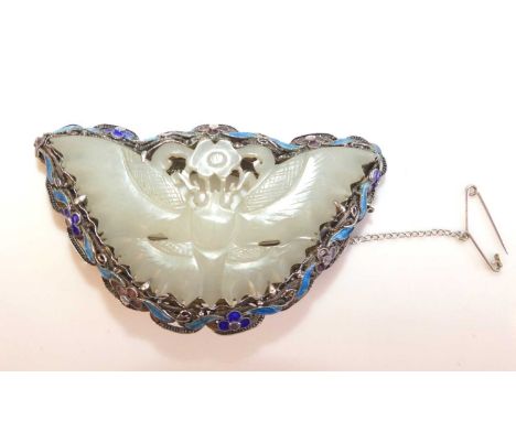 An Art Noveau style white metal butterfly brooch with carved jadeite centre and enamel border with floral detail.  Brooch dim