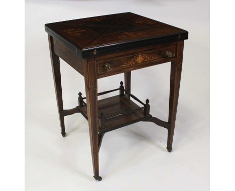 An Edwardian rosewood marquetry inlaid envelope card table, the top with swivel action and baize lined playing surface, openi