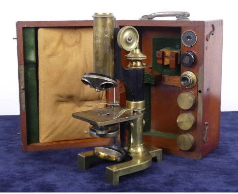An early 20th century lacquered brass microscope by M. Stiassnie of Paris, in fitted mahogany case, the microscope with hinge