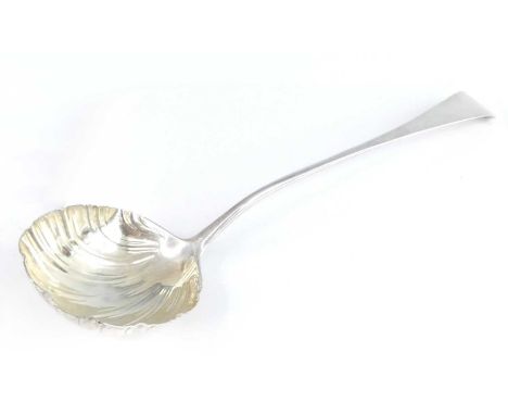 An early George III silver soup ladle, in the Old English pattern with a shell moulded gilt-washed bowl, makers mark WT or WJ
