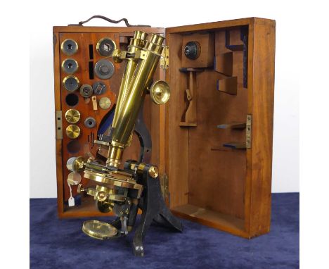 A late Victorian lacquered brass binocular microscope by Henry Crouch of London, numbered 3559, together with various accesso