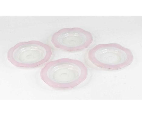 A set of four Stevens and Williams pink and vaseline glass saucers, circa 1880, each having a wavy threaded rim, dia.16.5cm