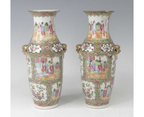 A pair of Chinese Canton porcelain vases, 19th century, each flanked by gilt lion mask handles, enamel decorated with interio