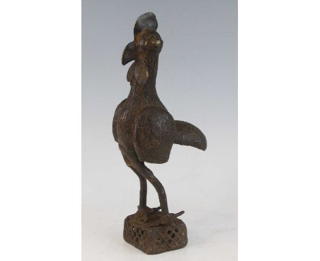 A bronze figure, modelled as a chicken with incised decoration on a pierced rectangular base, probably Benin, West Africa, h.