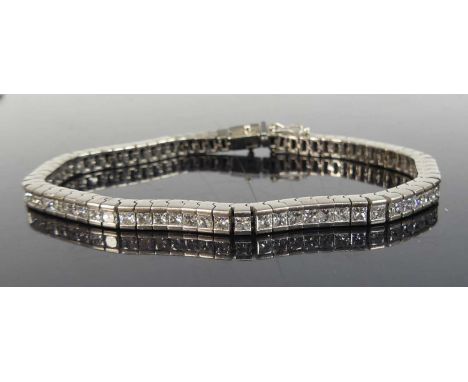 An 18ct white gold diamond articulated line bracelet, comprising 75 princess cut diamonds in channel settings, with box clasp