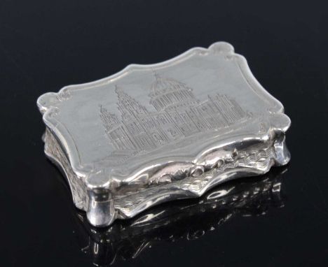 An early Victorian silver vinaigrette, of shaped rectangular form with reeded scrolling borders, the cover with engraved view