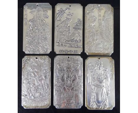 A collection of six Chinese silver ingot pendants / scroll weights, each of shaped rectangular form, relief cast to one side 