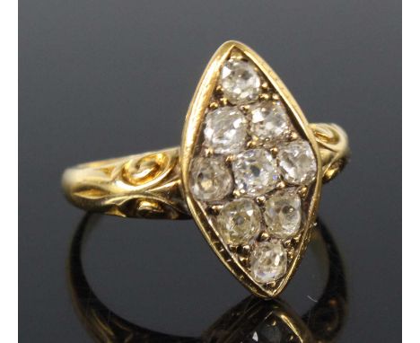 A late Victorian yellow metal diamond navette shaped cluster ring, comprising nine old cushion cut diamonds in grain settings