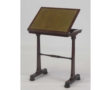 A Regency mahogany and brass inlaid reading table, having a gilt-tooled leather inset hinged and sloping writing surface, the