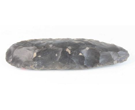 A large Neolithic flint axe head, circa 7th-5th millennium BC., 34cm.Length is approx 34cm as described. Consigned from a loc