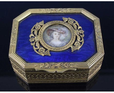 A late 19th century French gilt metal and enamel table snuff box, of canted rectangular form, the blue enamelled hinge cover 