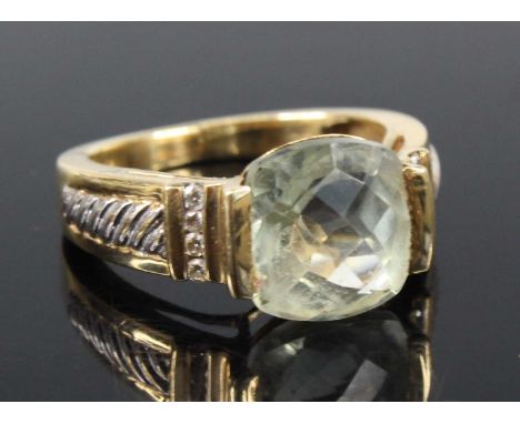 A yellow metal, green quartz and diamond dress ring, featuring a cushion cut green quartz in a semi-bar setting, with four me