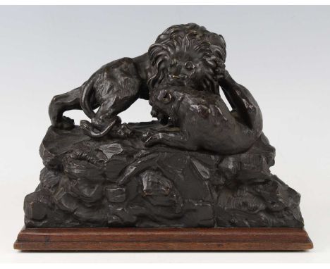 A circa 1900 continental animalier bronze group, modelled as a male lion attacking a lion cub, all upon a rocky base, unsigne