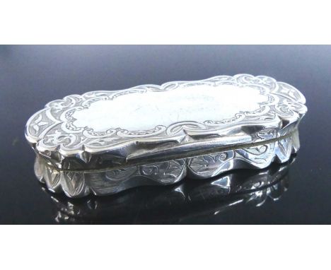 A Victorian silver snuff box, of shaped rectangular form with hinged cover, all-over bright cut engraved with scrolling geome