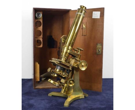 A late Victorian lacquered brass monocular microscope by Ross of London, numbered 4139, with spare lenses and optics, in fitt
